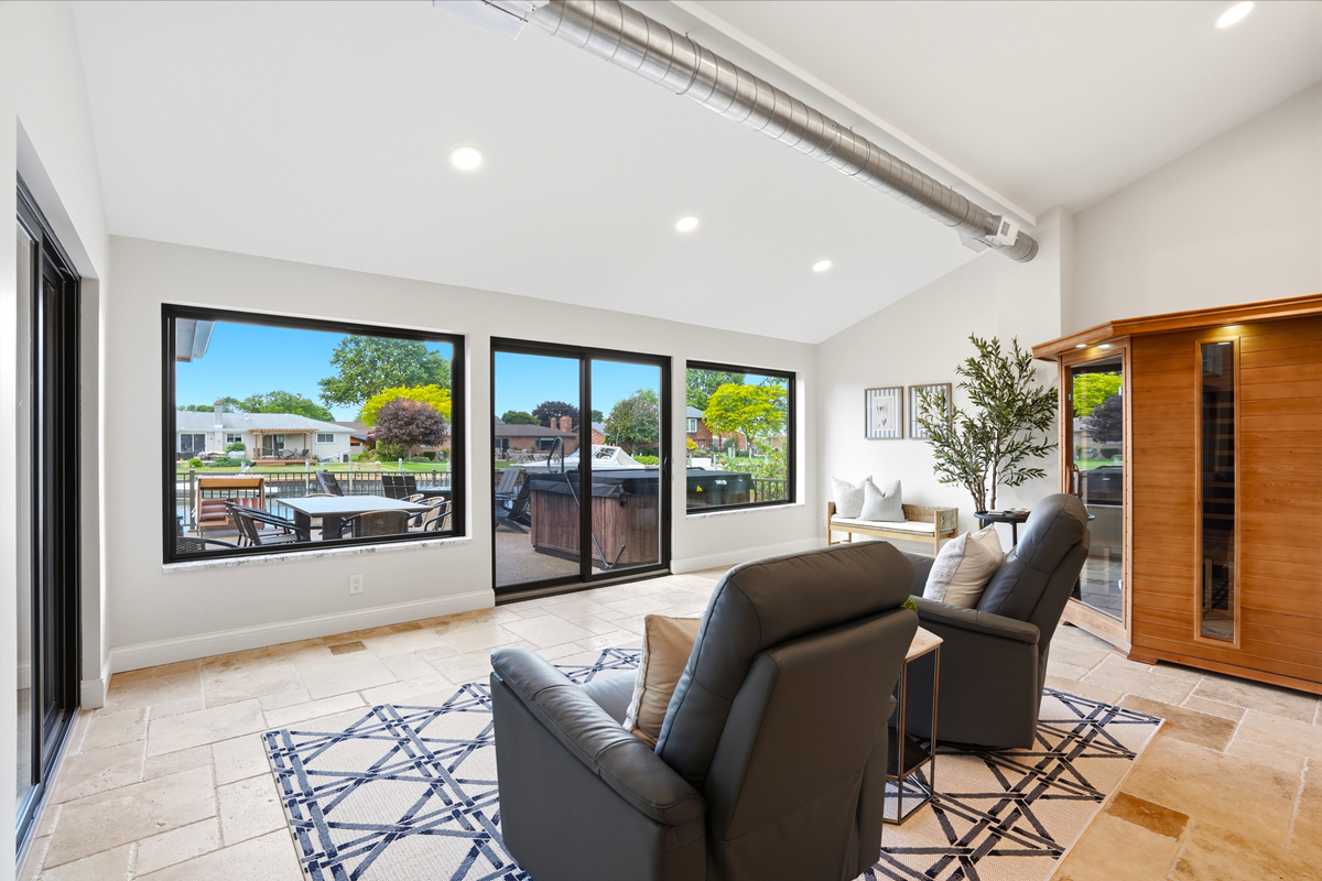 Bright and modern lounge with large windows offering abundant natural light and outdoor views. Comfortable seating, open layout, and clean design create a relaxing, stylish space perfect for unwinding or socializing.