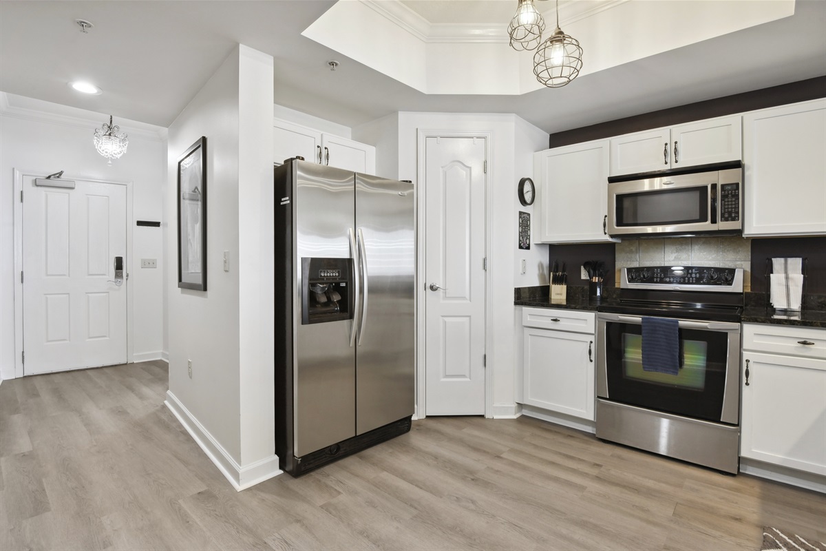 Kitchen down hall into foyer and front door.