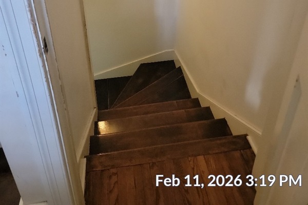 Interior stairs from ground floor to basement level with laundry room