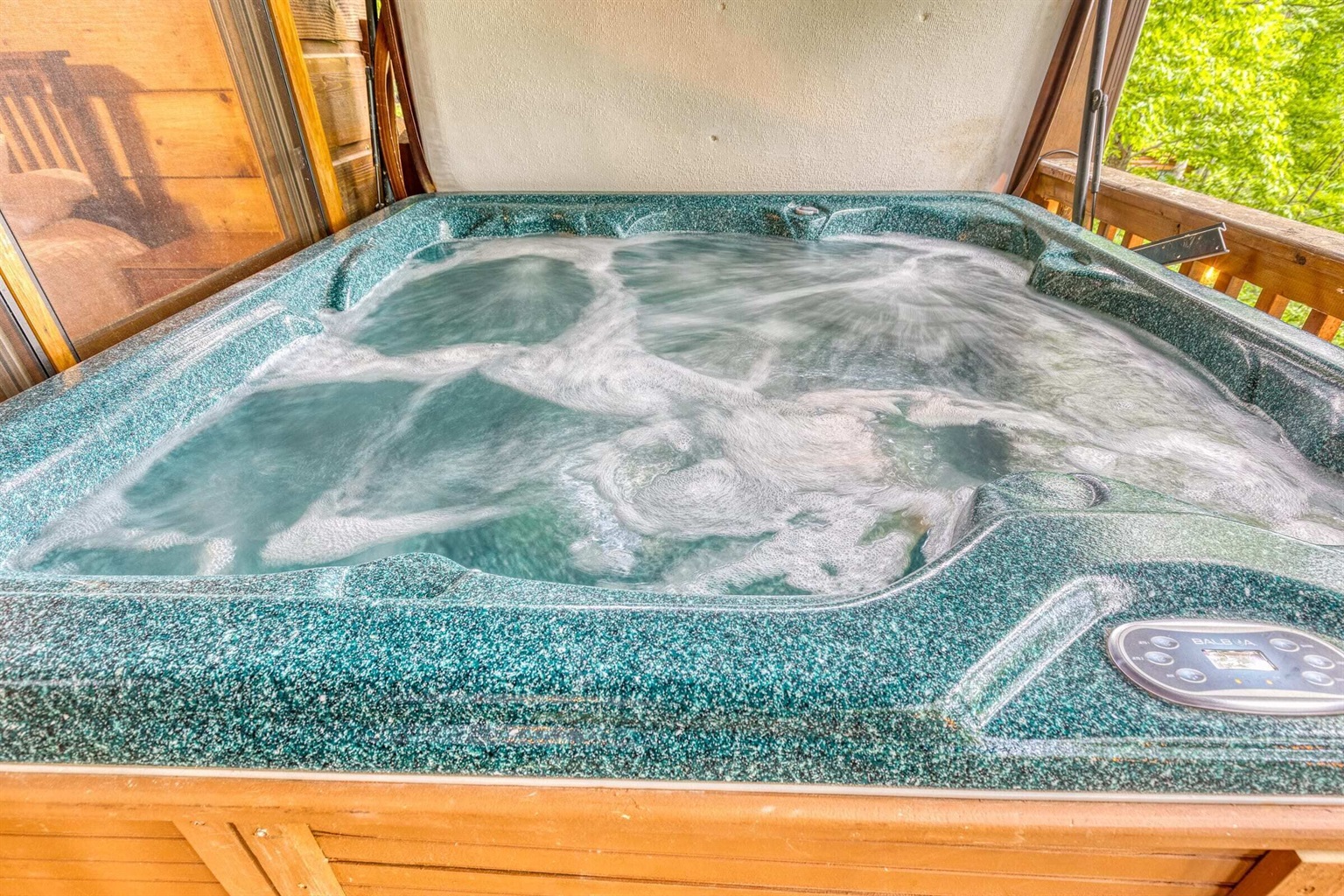Hot tub on outdoor deck for enjoying some water and nature.