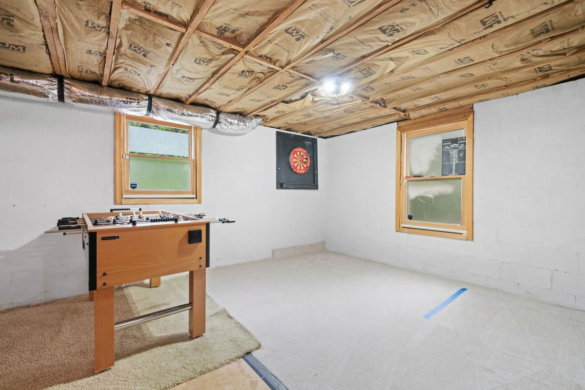Dark board and fuzball table in basement