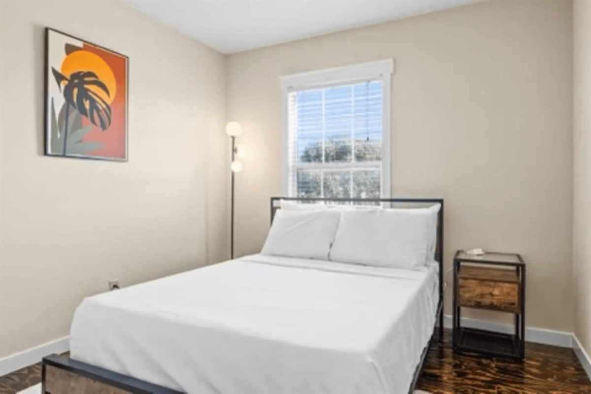 Bright bedroom with comfortable bedding, bed linens, and closet space for an easy and comfortable stay.
