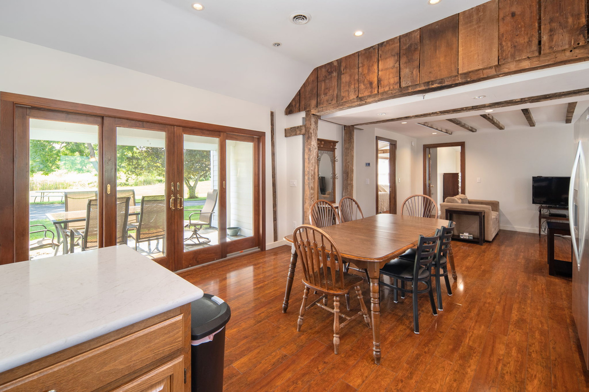Original wood beams bring historic character to the bright, open dining space.