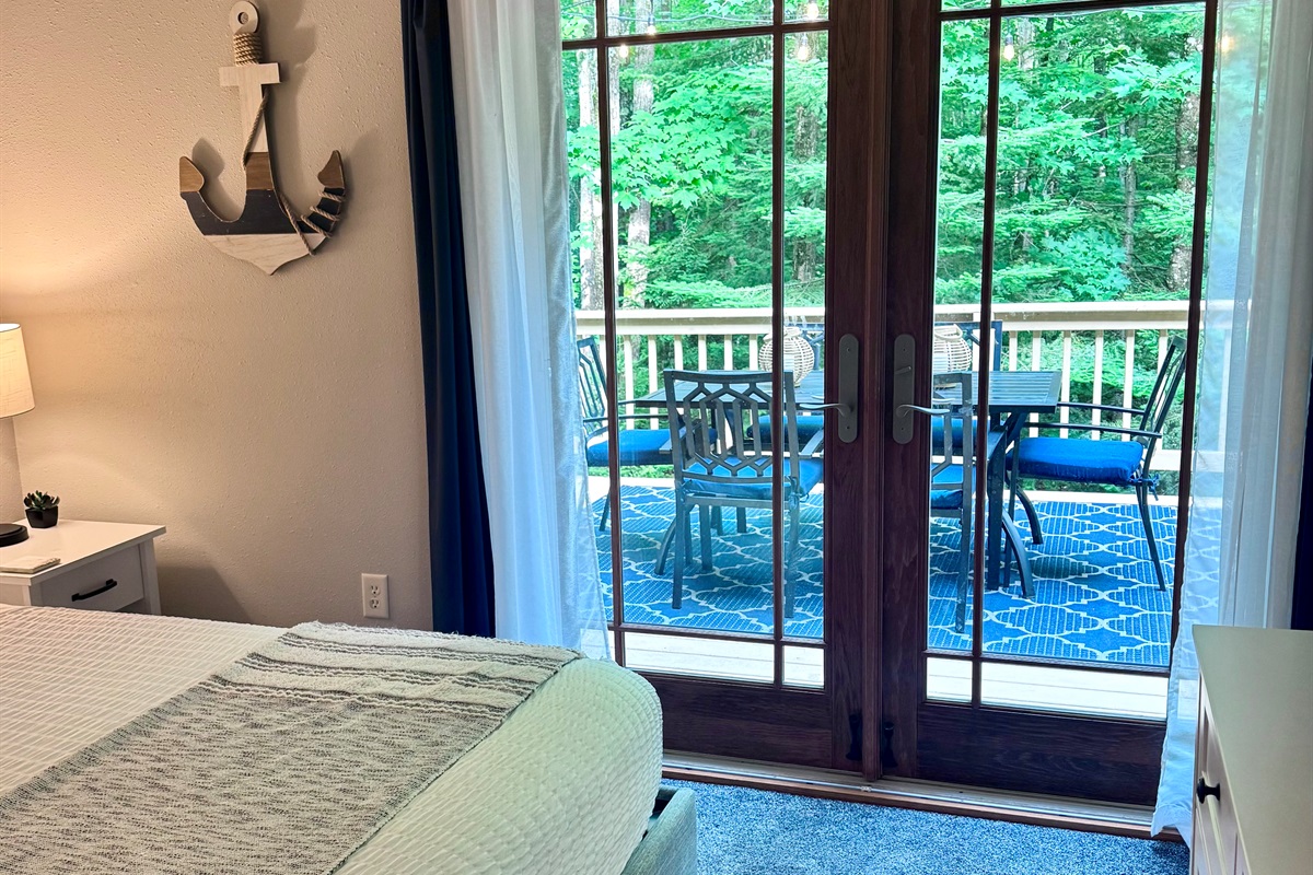 View out the bedroom through  French doors dining table for 6