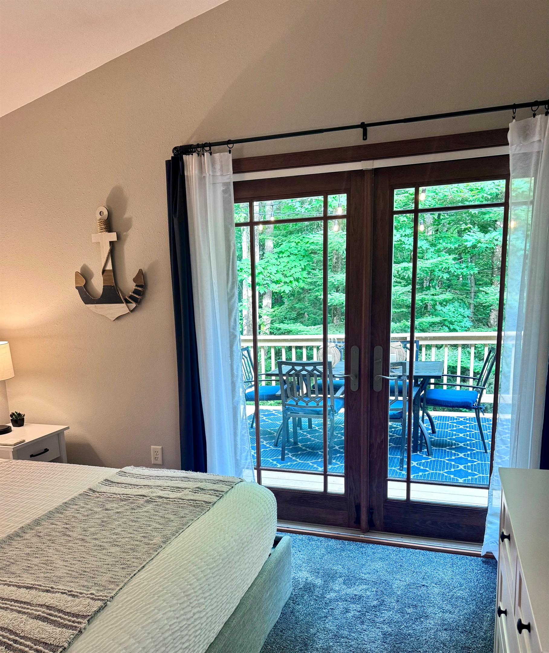 View out the bedroom through  French doors dining table for 6