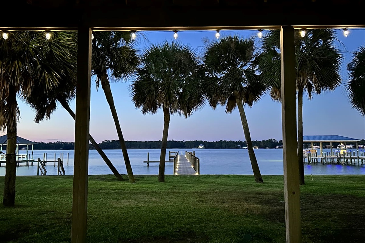 Twilight tranquility by the lake with palm trees, serene water, and cozy vibes.