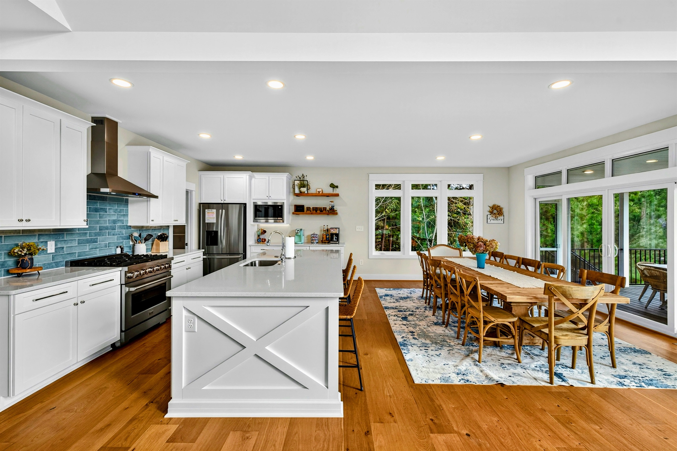 Gorgeous gourmet kitchen with 10 ft quartz island, Restoration Hardware dining table seating 12 and walk-in pantry stocked with all the basics.  Walk out to large screen porch with lake views!