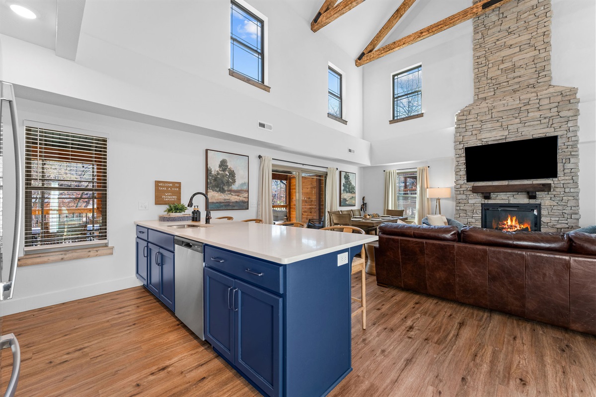 Bright kitchen island view overlooking the living space and fireplace.