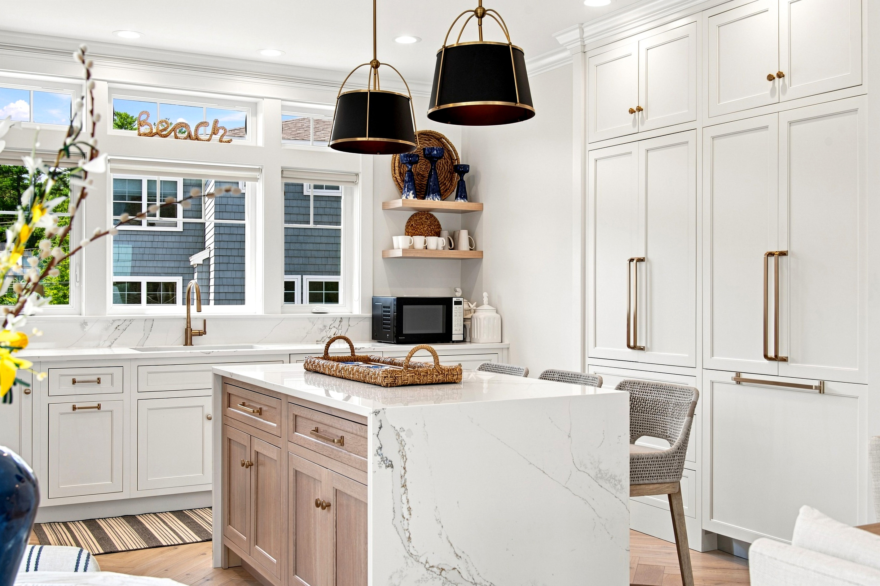 Clean coastal design meets everyday convenience in this spacious, light-filled kitchen.