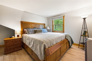 Bedroom with queen bed and window