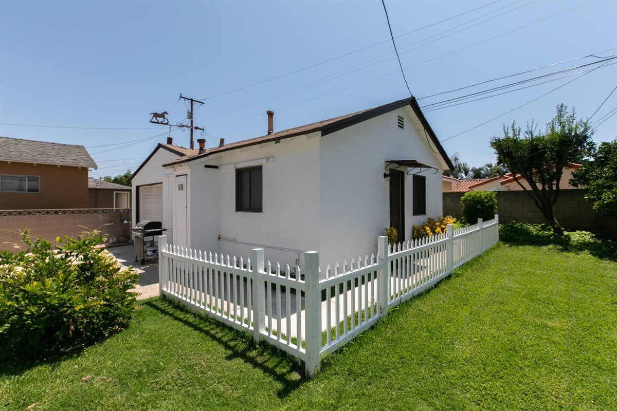 Comfortable studio suite with living, dinning, bedroom, bathroom, patio. Garage contains a washer and dryer as well as bikes.