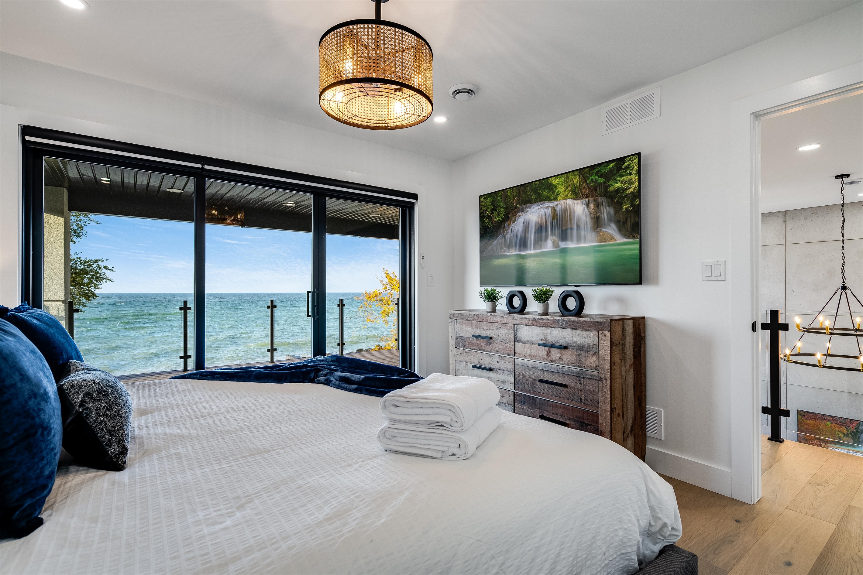 King Bedroom with Blue pillows pop against neutral bedding.