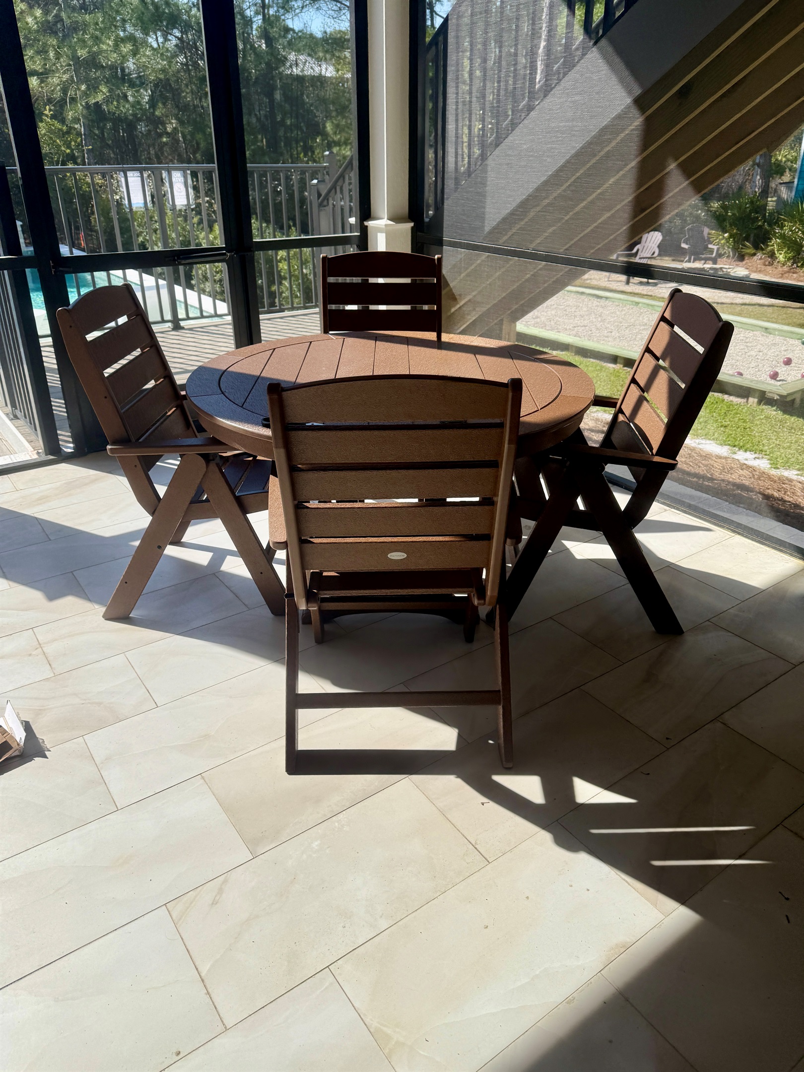Covered outdoor dining for four—ideal for poolside snacks or as extended seating, expanding total dining capacity at the main house to 16 guests