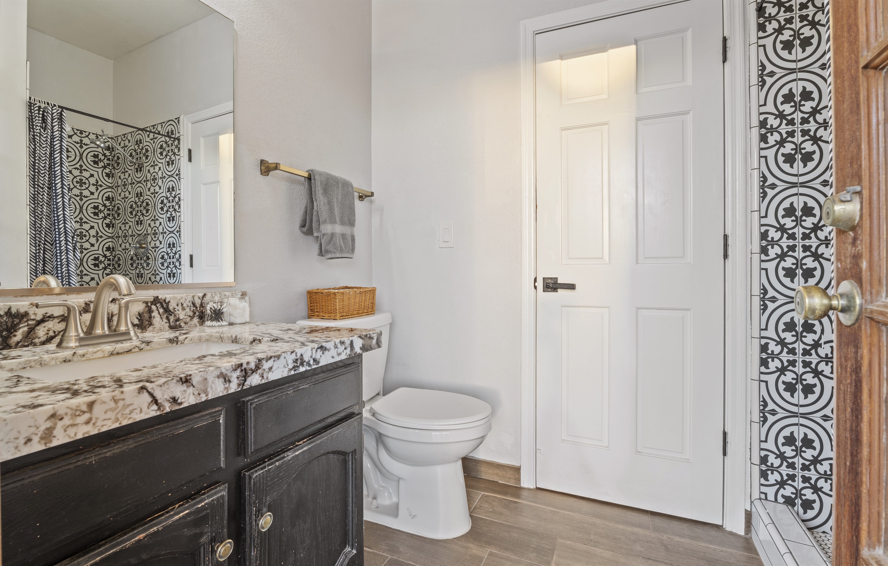 Elevate your stay with this chic bathroom featuring custom tile, a stone countertop, and a spa-style shower experience.
