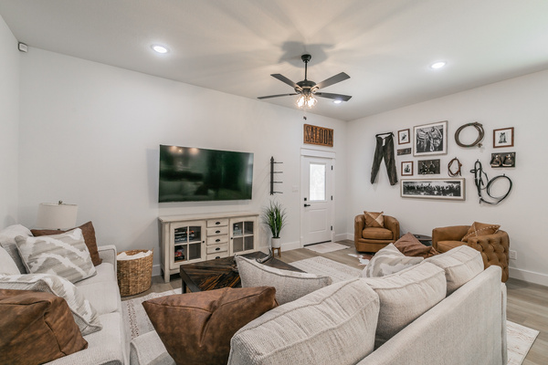 Western-themed living area with comfortable couches, chairs, and smart TV