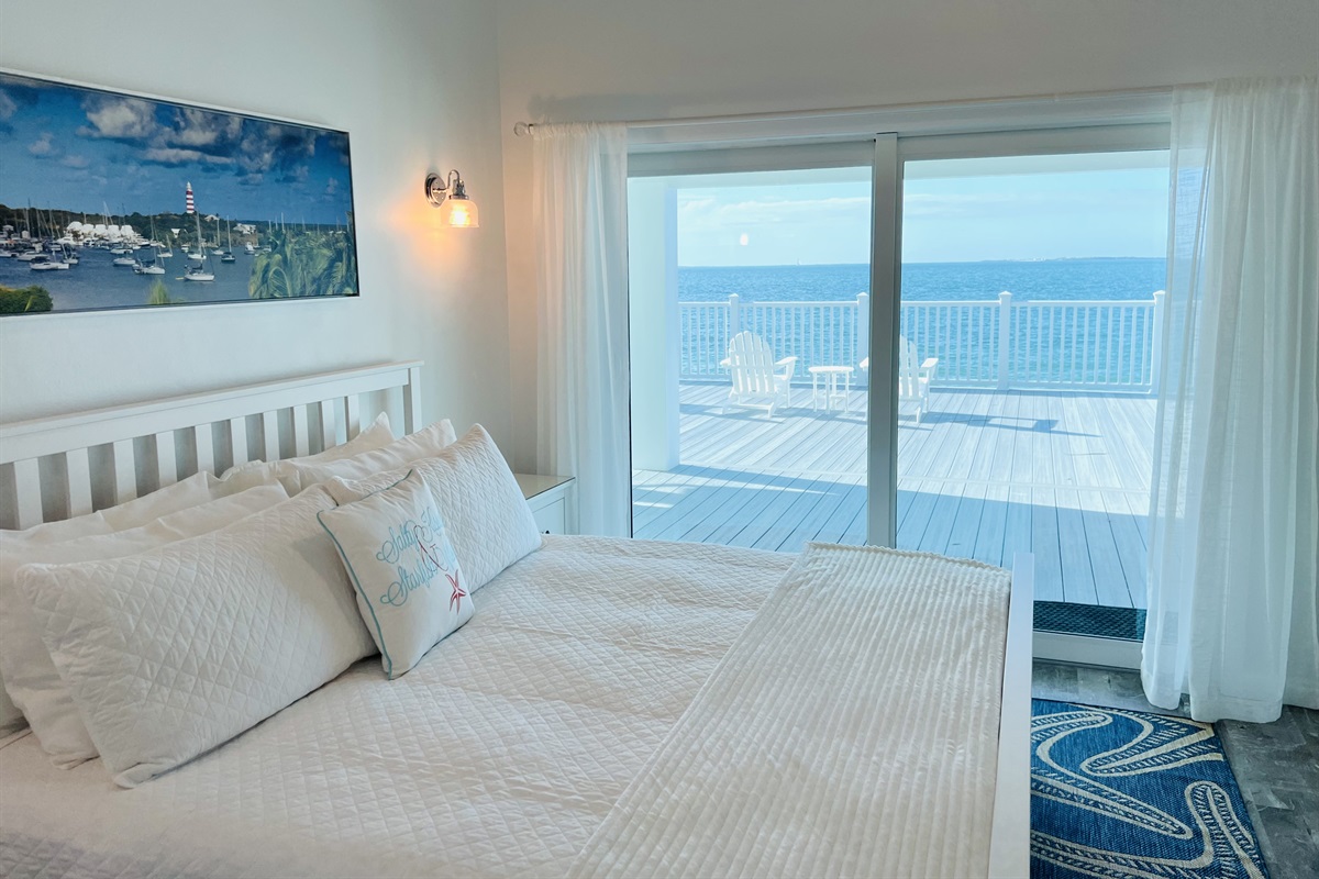 STARFISH BAY - Master bedroom with sliding doors onto the covered patio and large outdoor deck