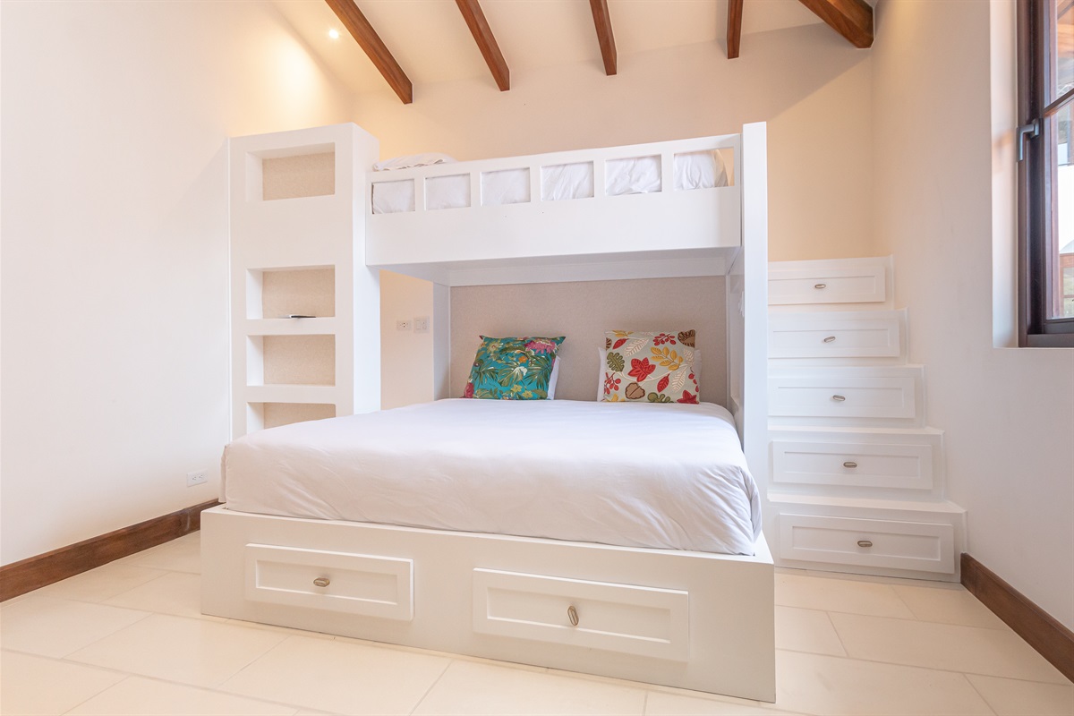 Bunk loft bedroom located in the right wing of the home with king bed and twin bunk.
