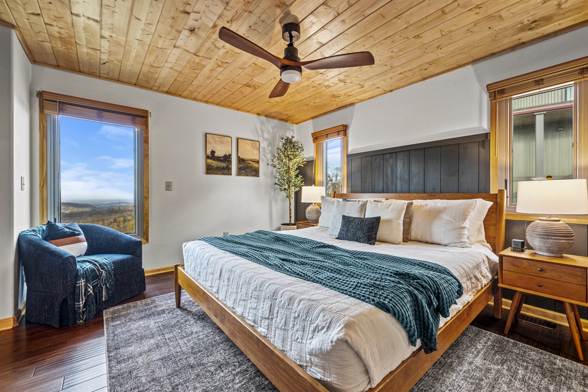 Main floor: Rest easy in the luxurious primary bedroom at Signature Stay, featuring a king-sized bed with soft cotton linens for the ultimate comfort and relaxation