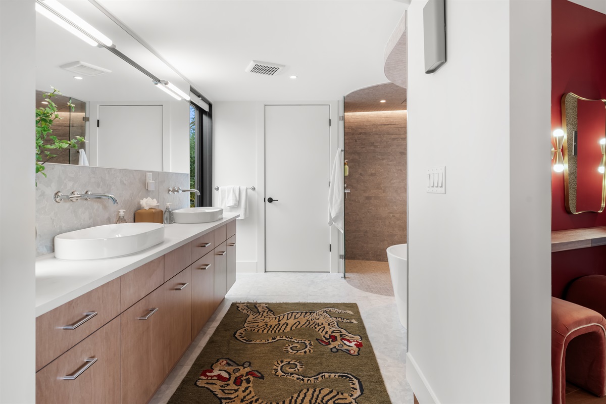 Spacious spa-style bathroom with dual vanities and modern finishes—perfect for getting ready comfortably and stress-free.