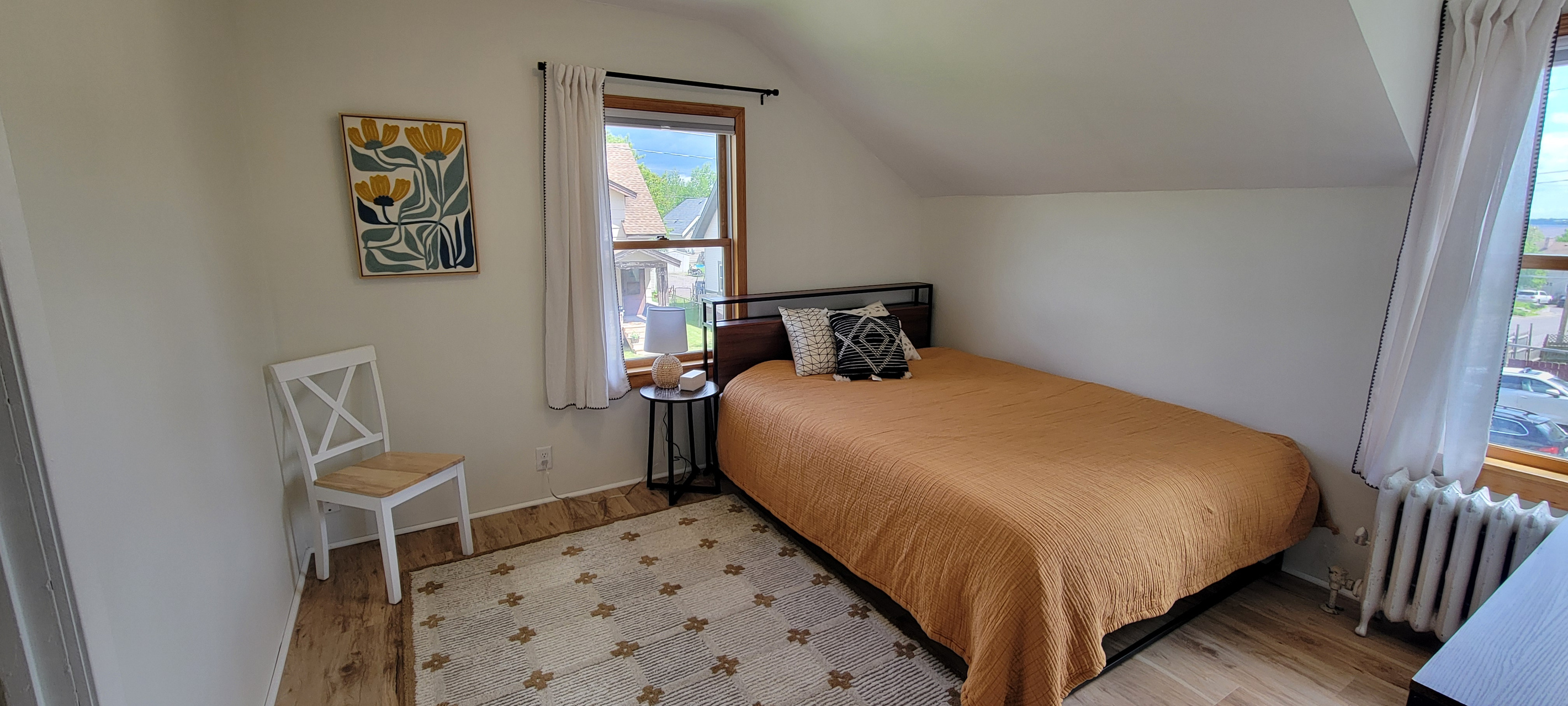 Second bedroom with queen bed and pull-out twin trundle — flexible sleeping space for families or groups.