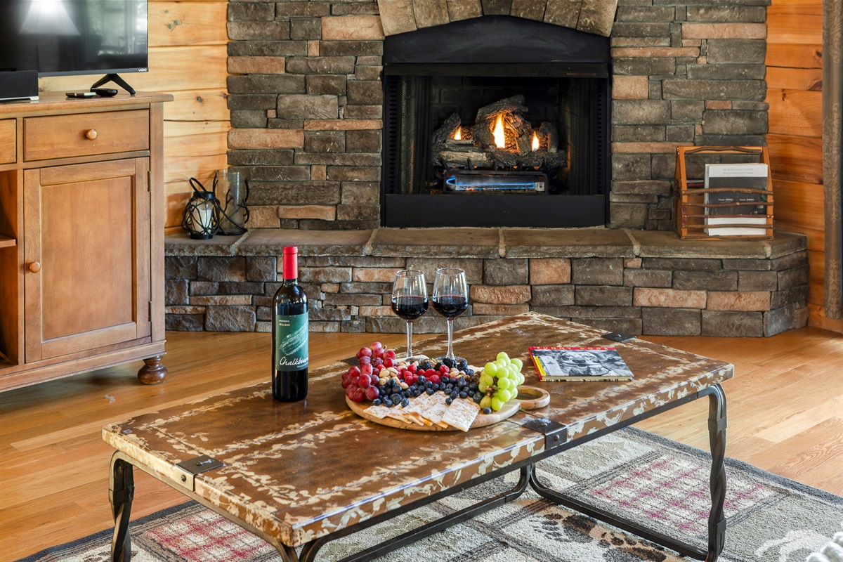 Living Room: Gather around the rustic charm, enjoy wine and views by the crackling fireplace!

