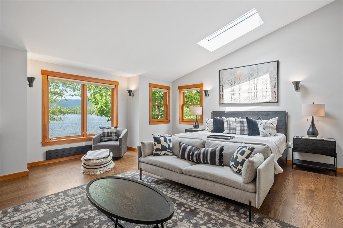 Second floor master bedroom ensuite with king bed and couch and its own bathroom