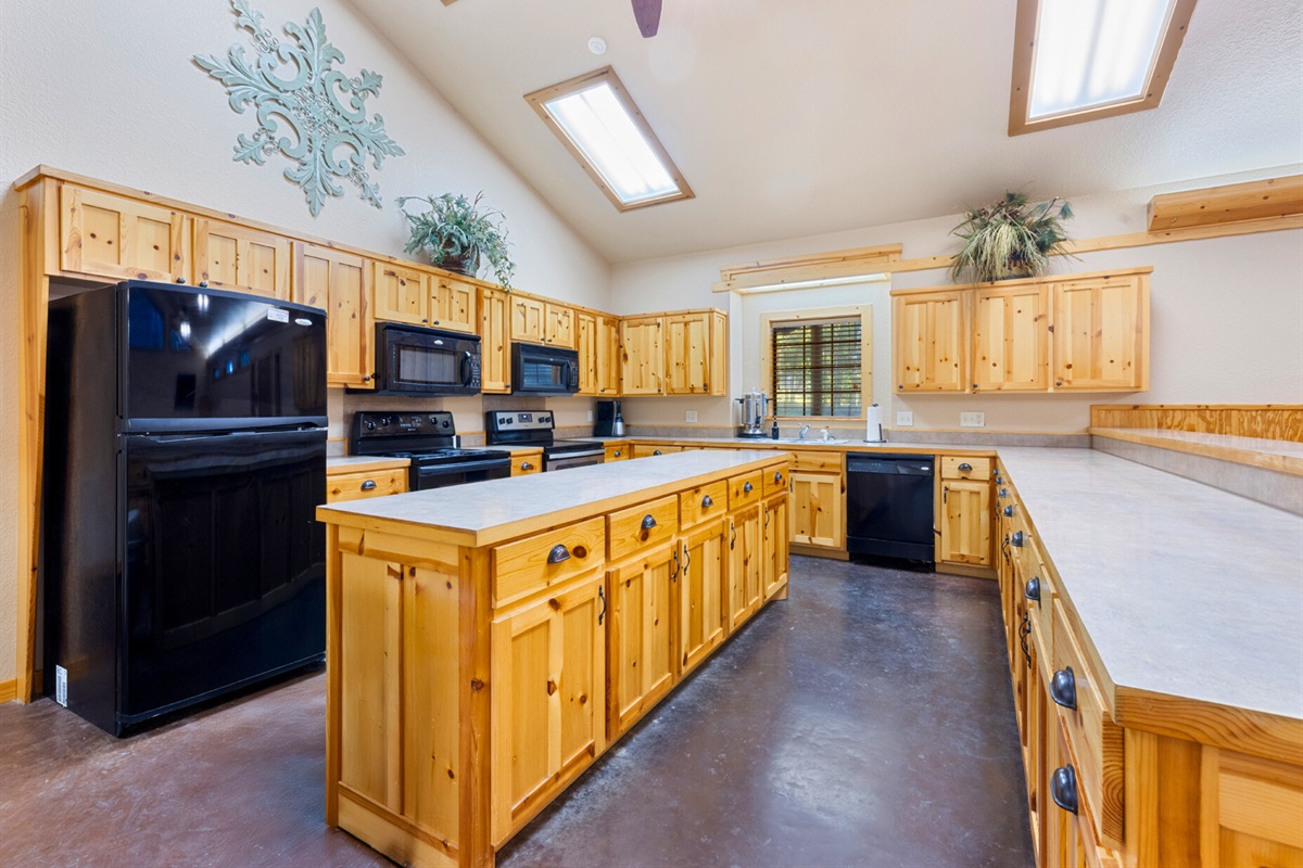 Multiple stoves and prep areas ensure there’s plenty of room for cooking together during events or large gatherings.