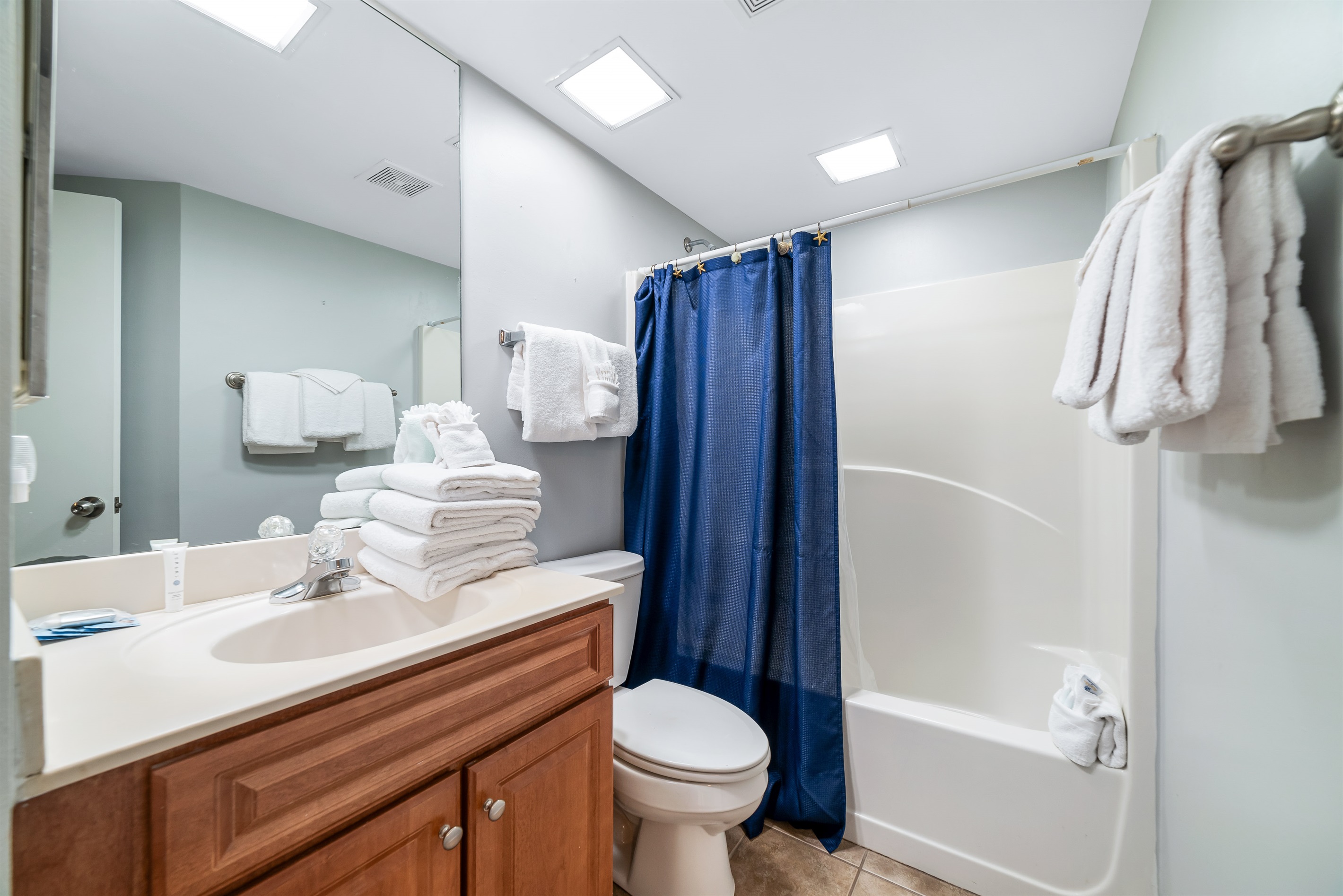 Freshly updated guest bathroom featuring a shower/tub combination, ample vanity space, and modern fixtures.