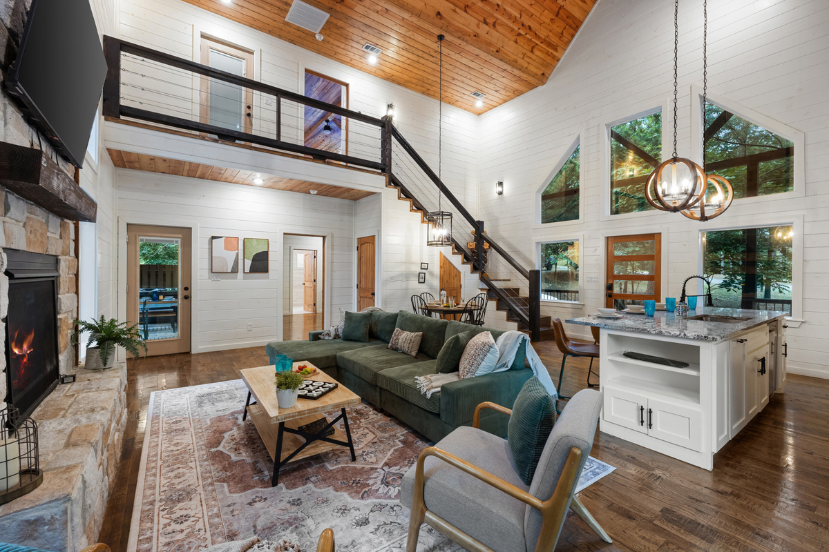 The heart of Hit Refresh, where cozy cabin moments naturally come together. 
A glowing fireplace, soaring ceilings, and open spaces designed for movie nights, slow mornings, and memory making with your favorite people.