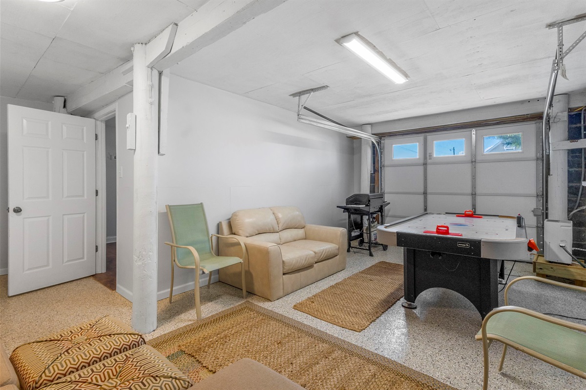 The Game Room has an air hockey table as well as ample comfortable seating! The grill can be moved outside through the garage door. And the grilling utensils are in the kitchen.