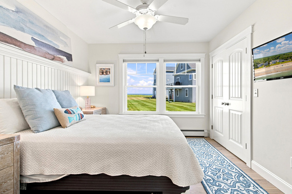 A bright, inviting bedroom with ocean views and plenty of natural light for relaxing vacation mornings.