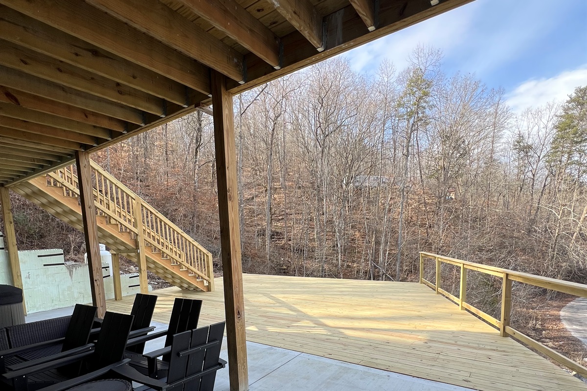 lower level with huge concrete patio and deck. Hang out in the hot tub or play a game of corn hole