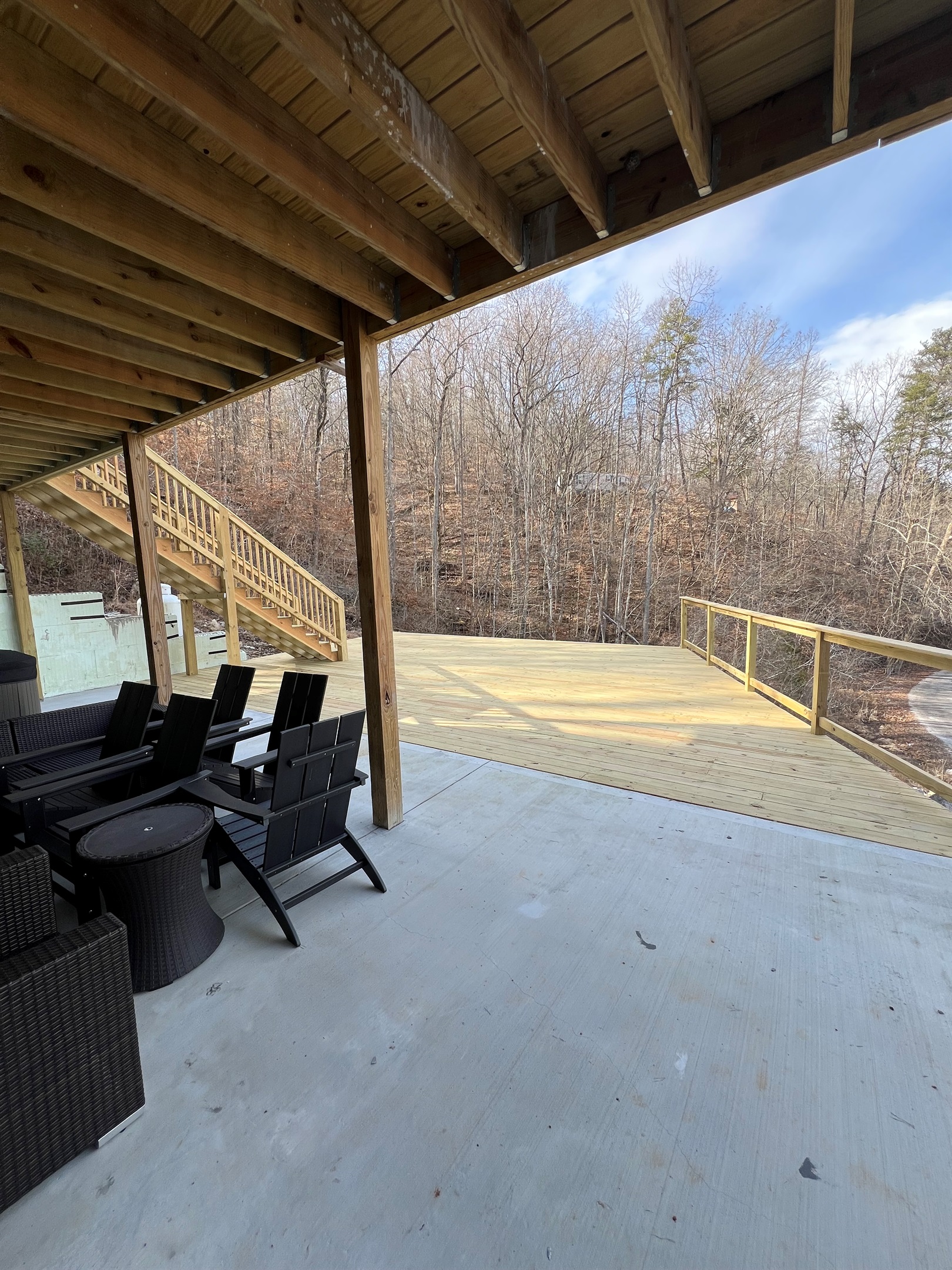 lower level with huge concrete patio and deck. Hang out in the hot tub or play a game of corn hole