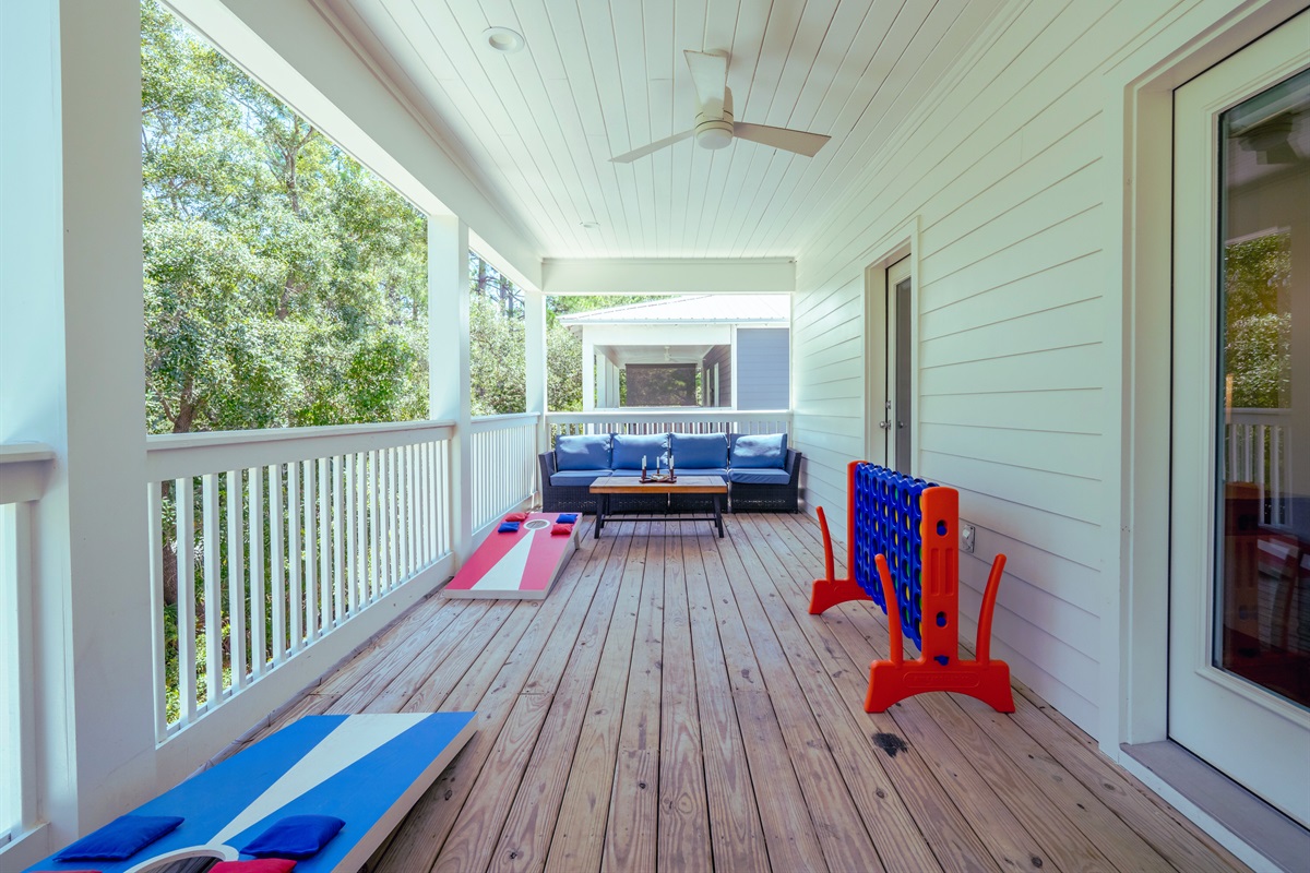 Spacious deck with seating areas, cornhole, and ring toss - perfect for outdoor fun and relaxing evenings