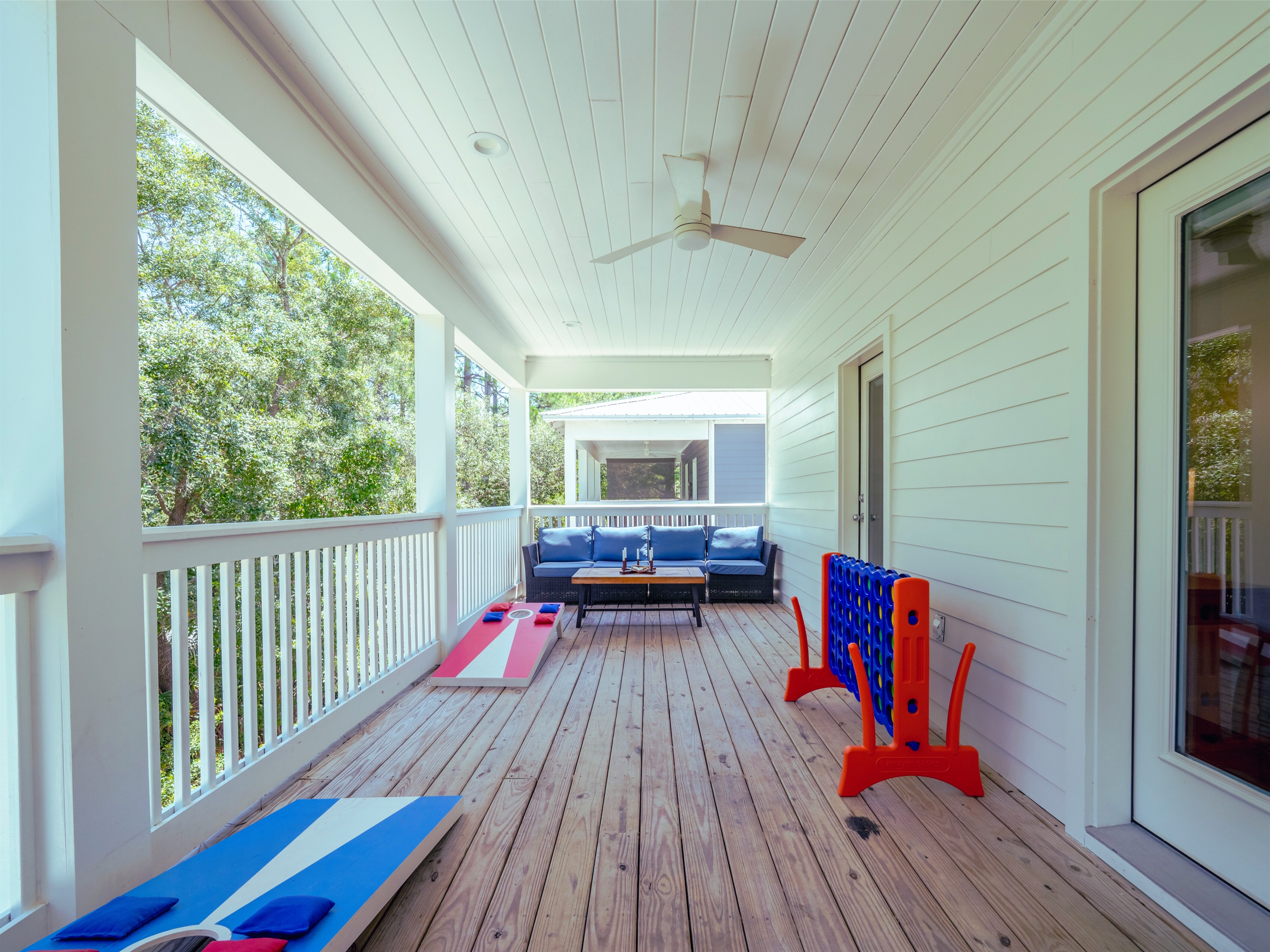 Spacious deck with seating areas, cornhole, and ring toss - perfect for outdoor fun and relaxing evenings
