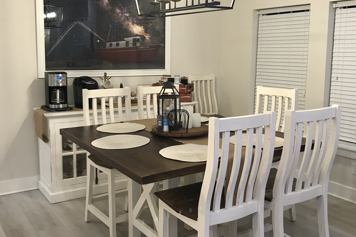 Dinner table fits eight and breakfast bar seats four more.