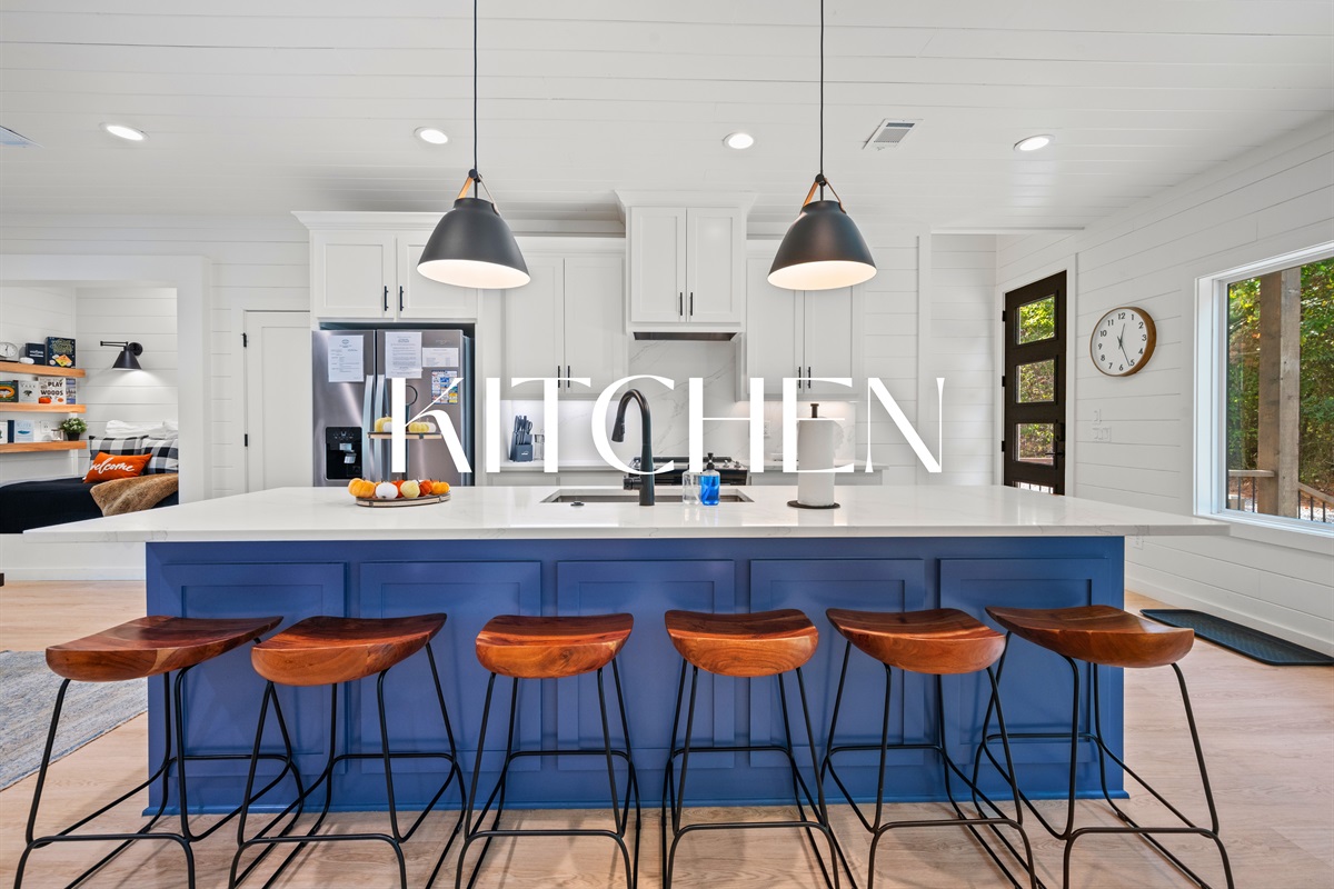 Spacious kitchen with large island and seating for five.