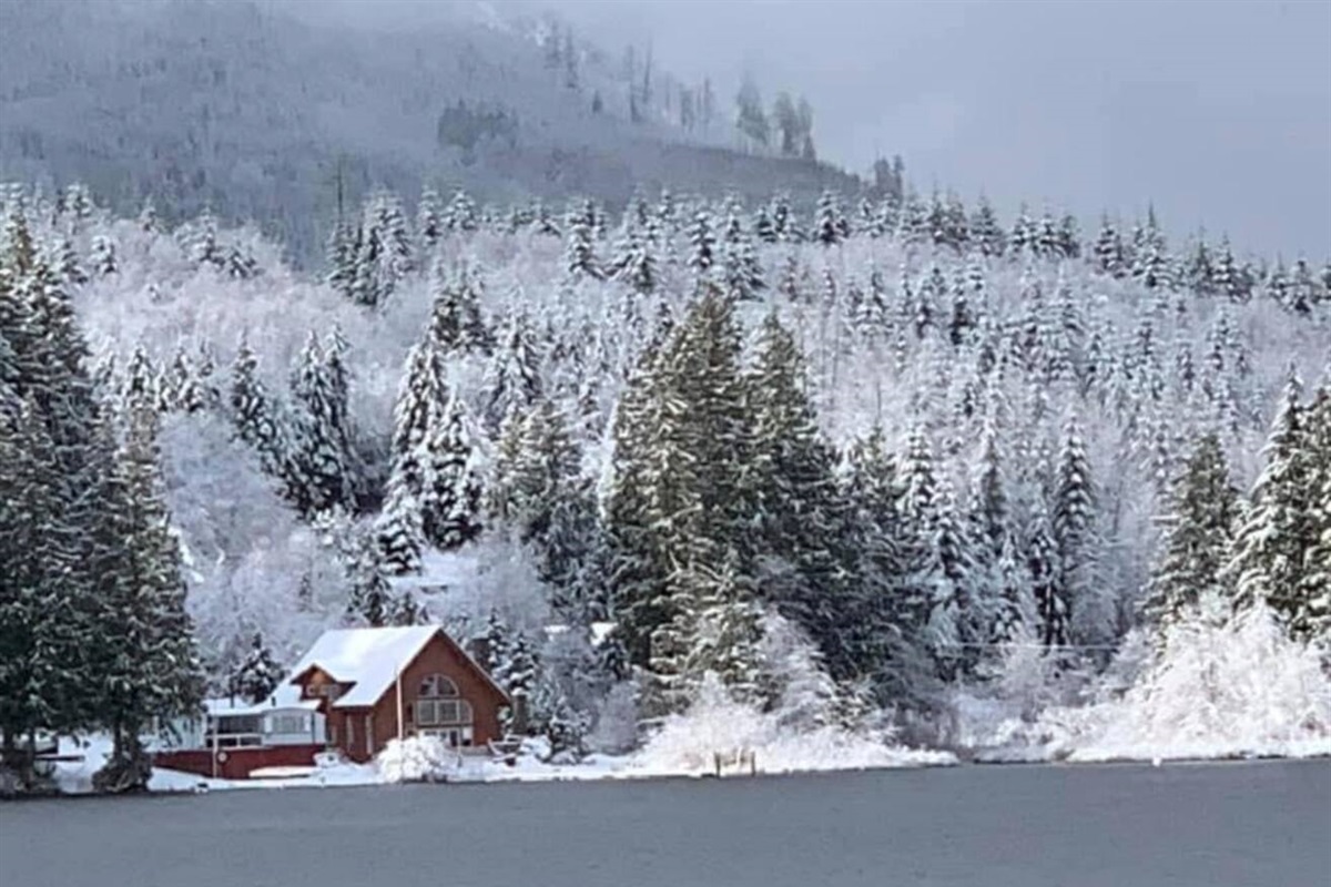 Calm winter lake with snow along the shoreline.