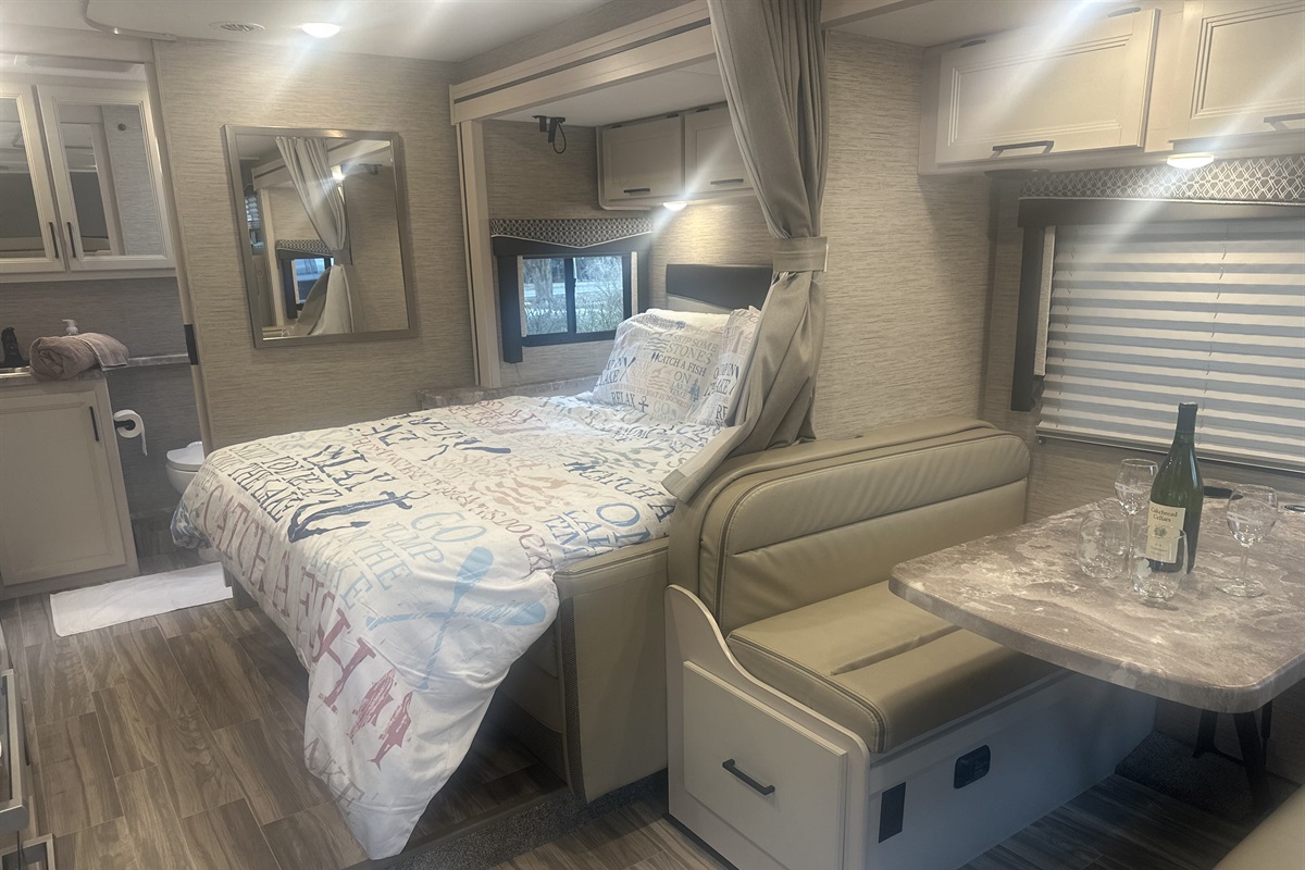 View of bed and dinette