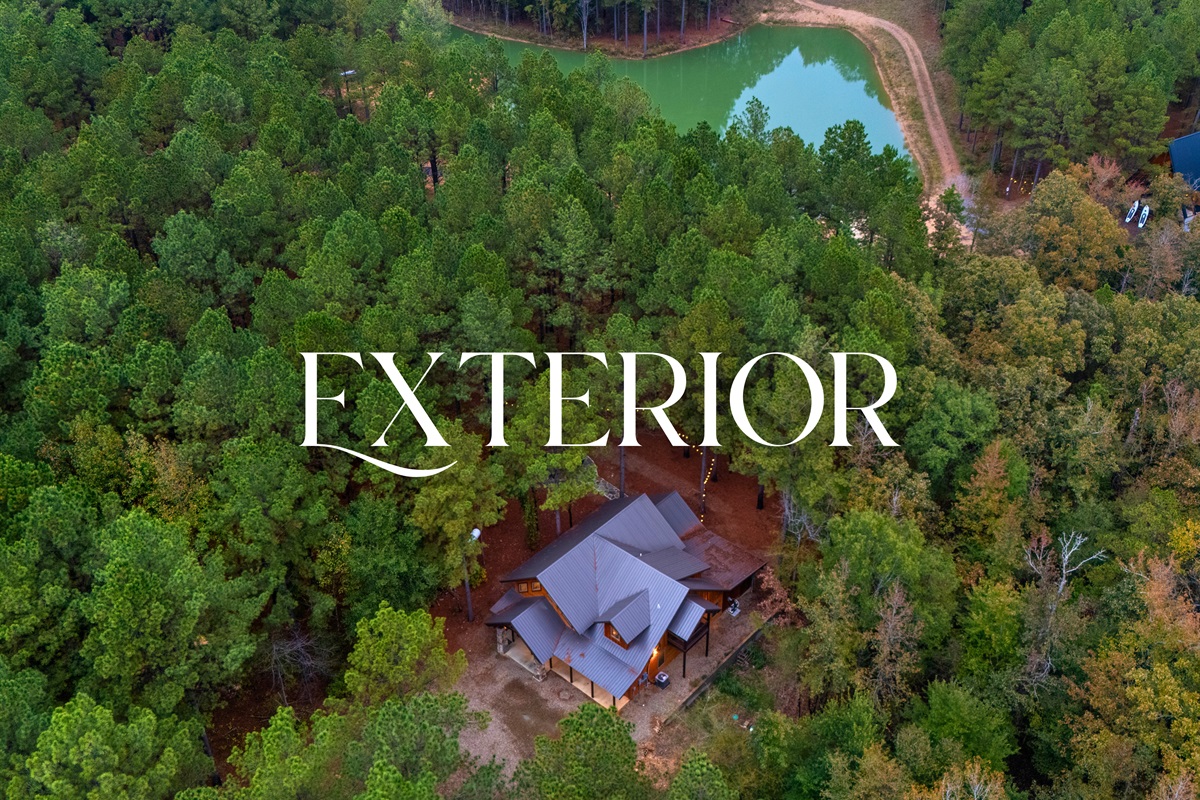 Aerial exterior of Wolf Creek nestled in the woods.