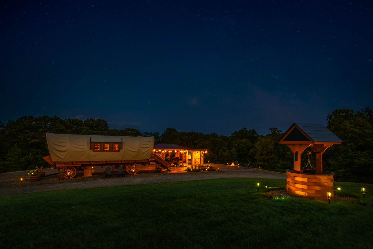 Wishing Well Wagon after dark — soft lights, privacy, and a peaceful Kentucky getaway setting.