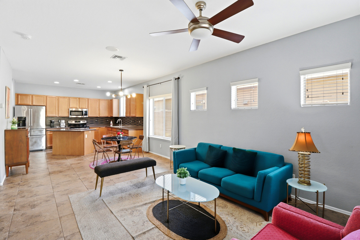 Living room with colorful seating, kitchen and dining nearby, and an easy spot to relax or watch TV.