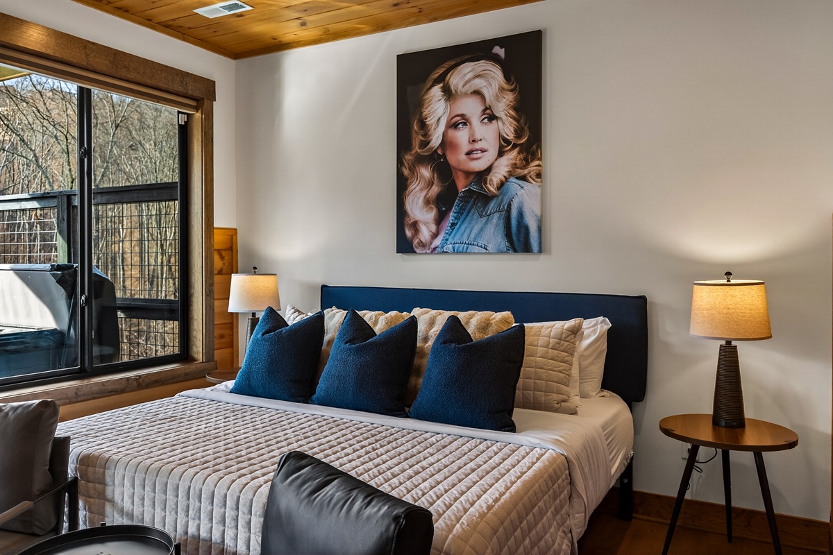 Relax in the spacious king bedroom on the game room level with a big TV, desk & direct deck hot tub access. Unwind in the en-suite bathroom featuring a walk-in shower with a natural river rock floor, bringing  the Smoky Mountains indoors for a spa retreat.