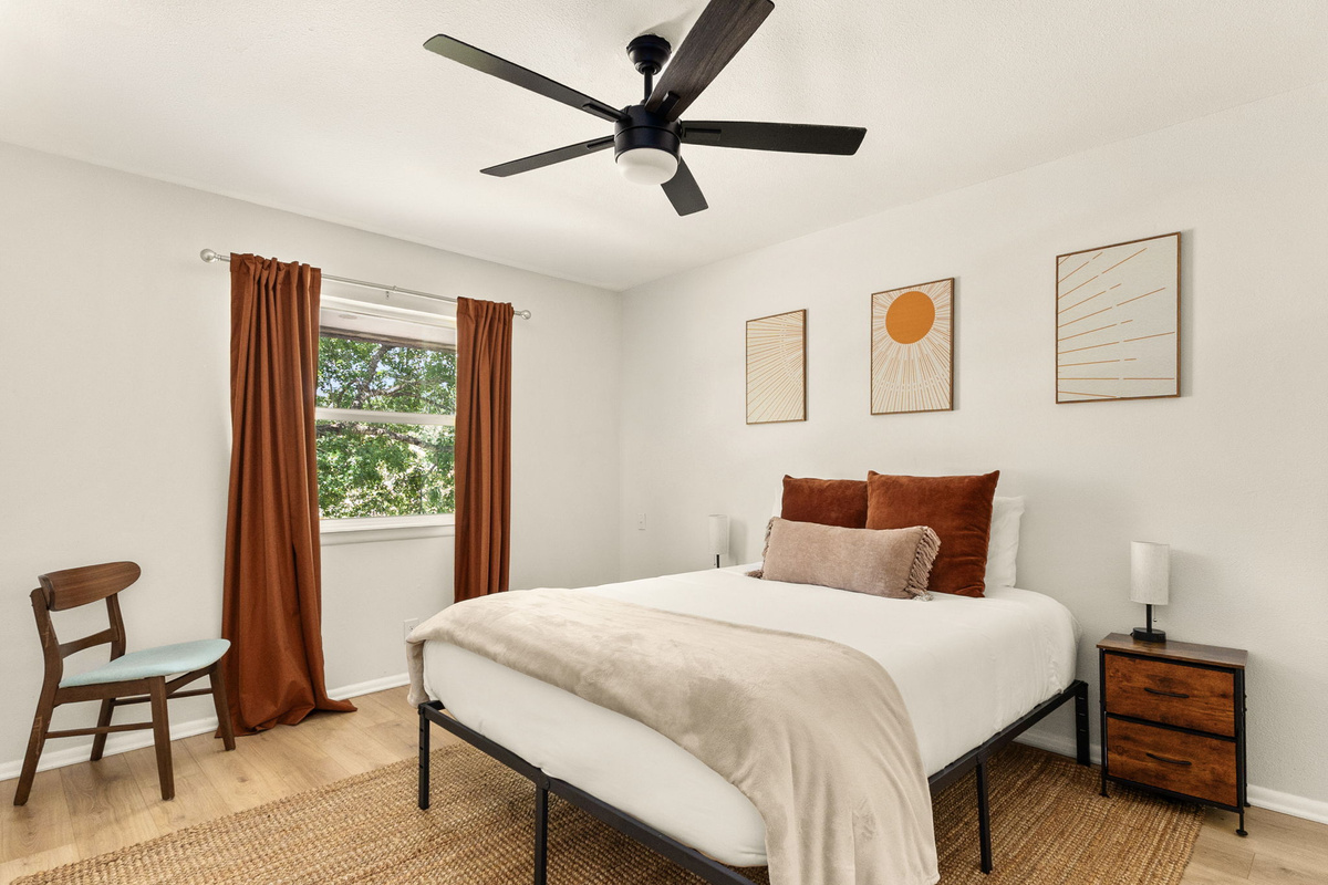 Wake up refreshed in this beautifully designed bedroom with natural light and cozy furnishings.
