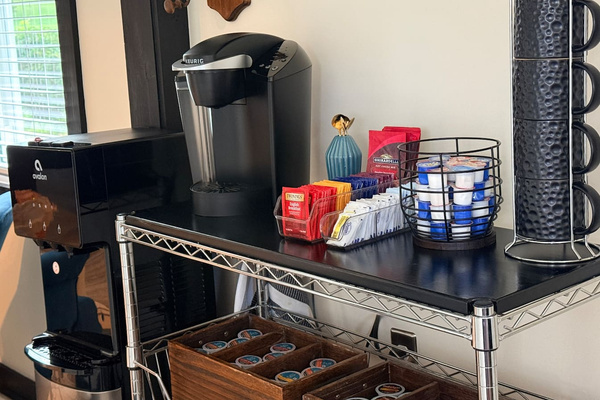 Coffee bar with Keurig and drip coffee options, tea, cocoa, cappuccino, and supplies.
