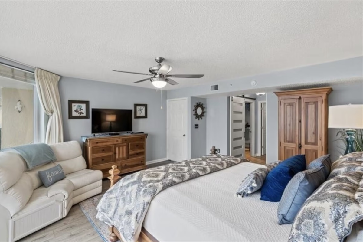 The primary bedroom has all the space you need and comes with a king bed and your own private access to the balcony