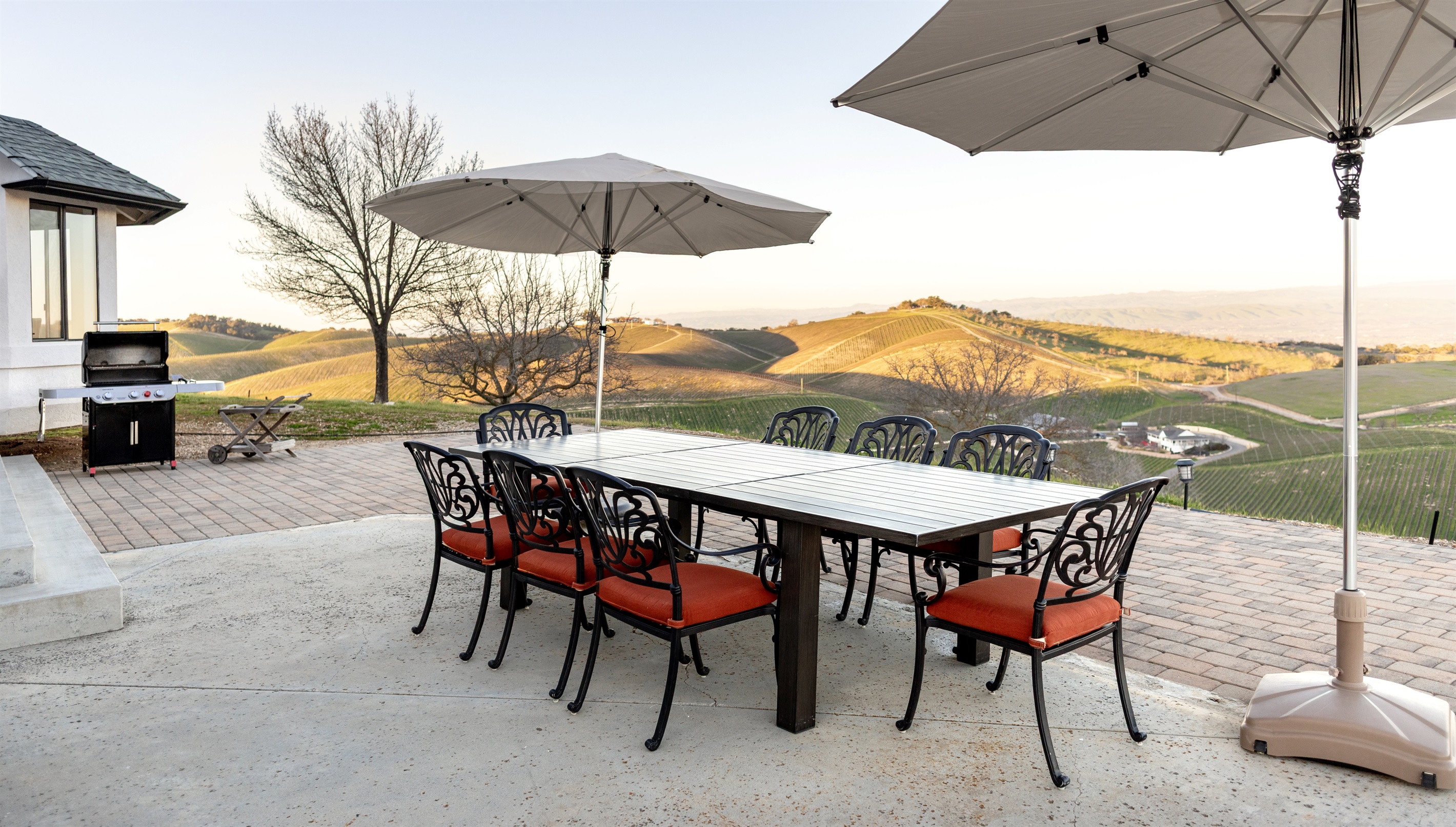 Dine al fresco above the vines. The outdoor patio seats ten with a full-size gas grill, vineyard views in every direction, and golden evening light that makes every meal feel like an occasion.