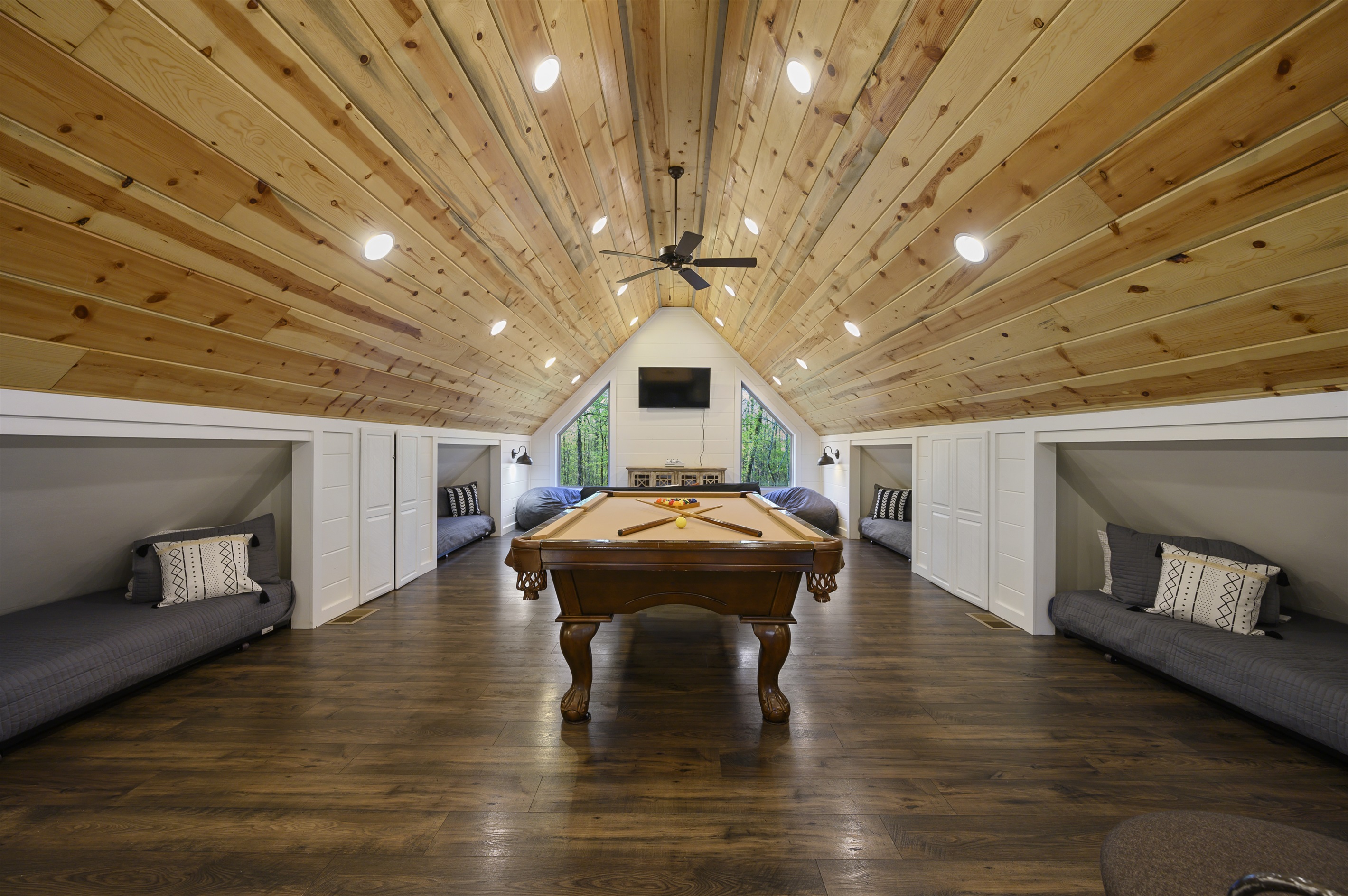 Game loft with high ceilings, a pool table, 4 loft beds that can be rolled out of knooks, smart TV & Xbox so you can stream from your accounts. Beds can be rolled out of knooks. Futon has been replaced with a sectional couch.
