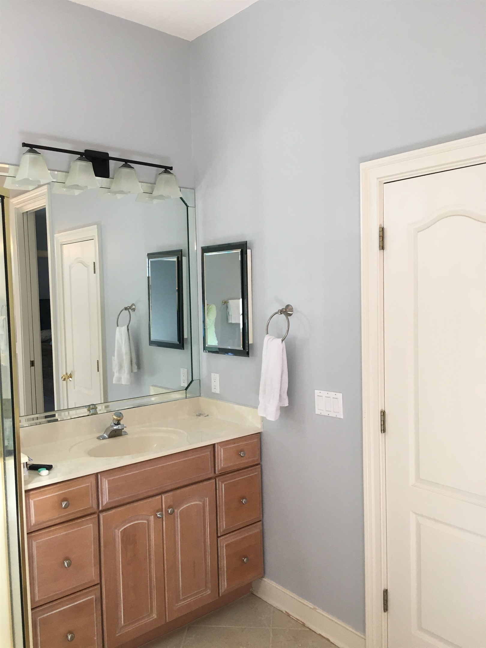 Two separate vanities (one shown) and a linen closet