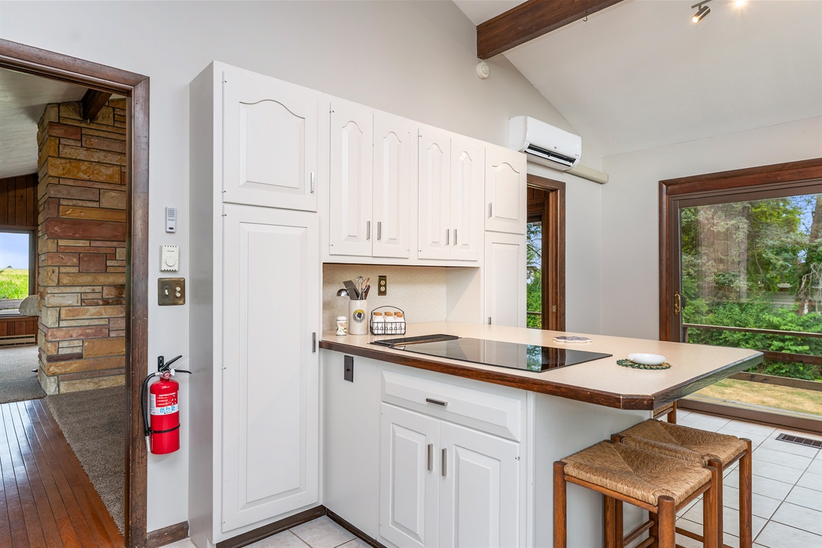Enjoy meals and conversation around the large center island with seating for four, set in a stylish kitchen with ample storage.
